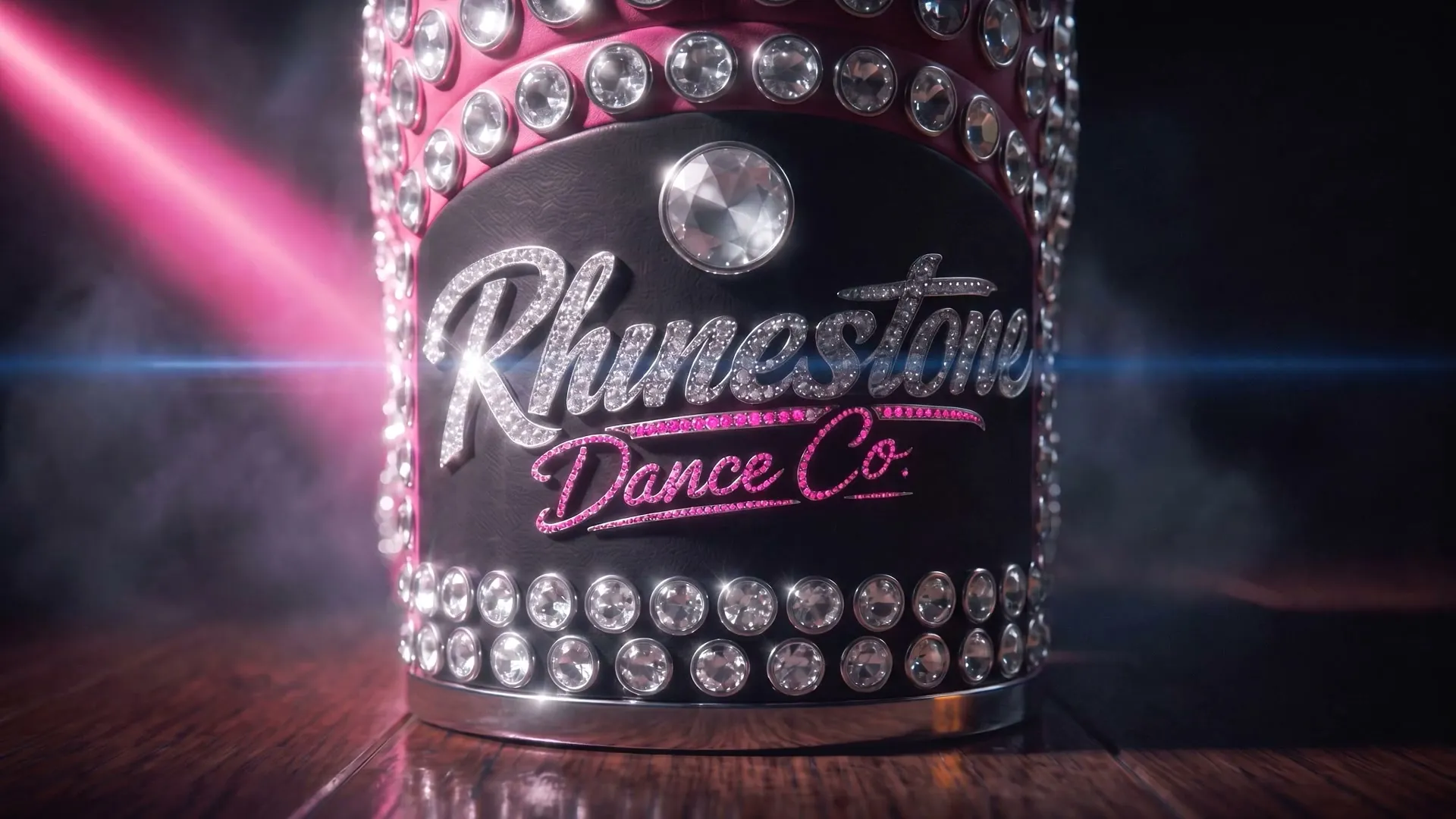 Close view of the boot’s rear heel medallion with Rhinestone Dance Co. spelled in silver-white and hot-pink crystal lettering.